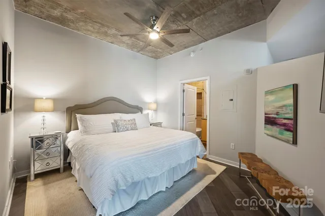 a bedroom with a bed and a chandelier