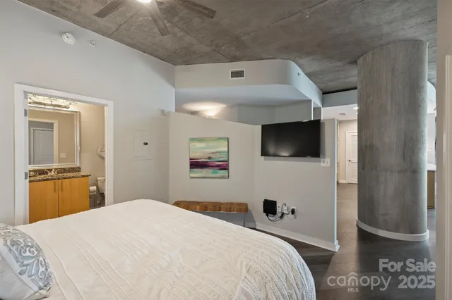a bedroom with a bed and flat screen tv