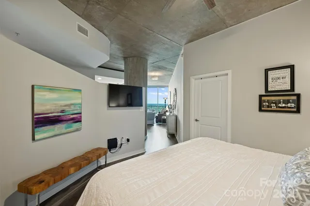 a bedroom with a bed and a flat screen tv