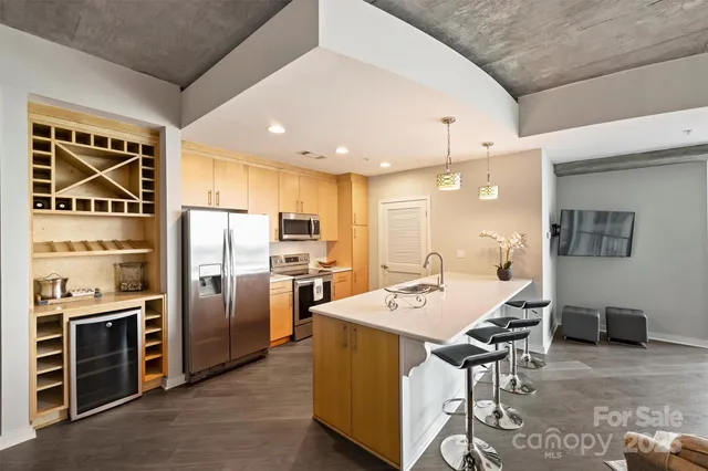 a kitchen with kitchen island a counter top space appliances and cabinets