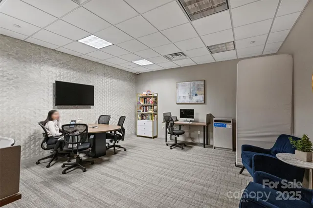 a view of a livingroom with workspace and a couch