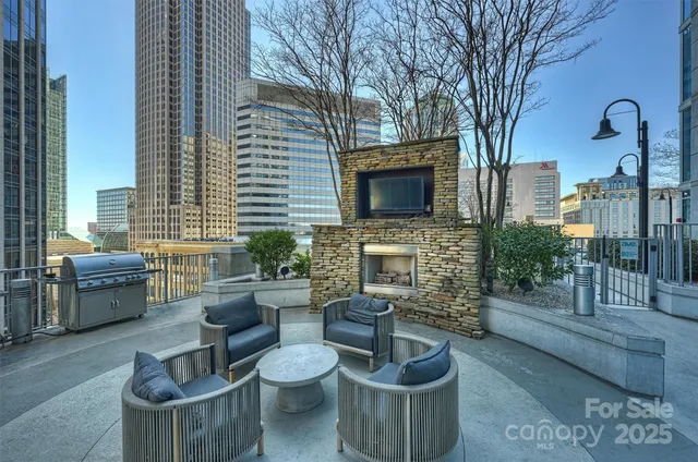 a view of a patio with couches chairs and a fire pit