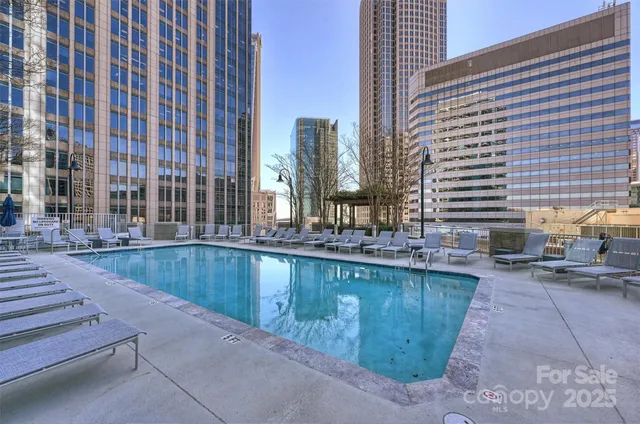 a view of swimming pool with outdoor seating