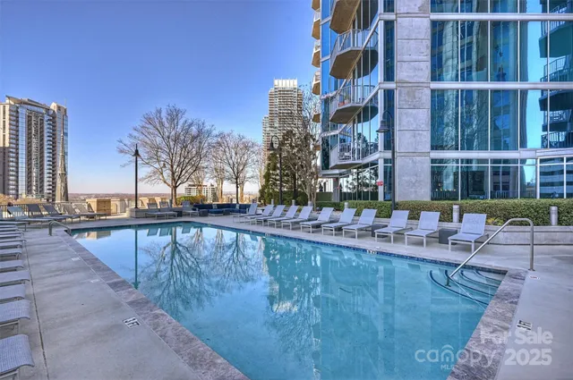 a view of swimming pool with outdoor seating and plants