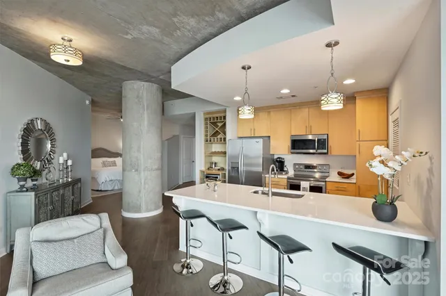 a kitchen with kitchen island a large counter top space appliances and cabinets