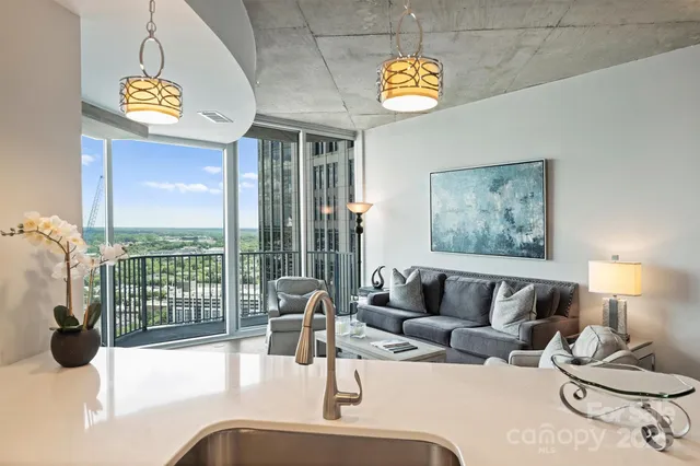 a living room with furniture and a floor to ceiling window