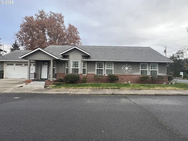a front view of a house with a garden