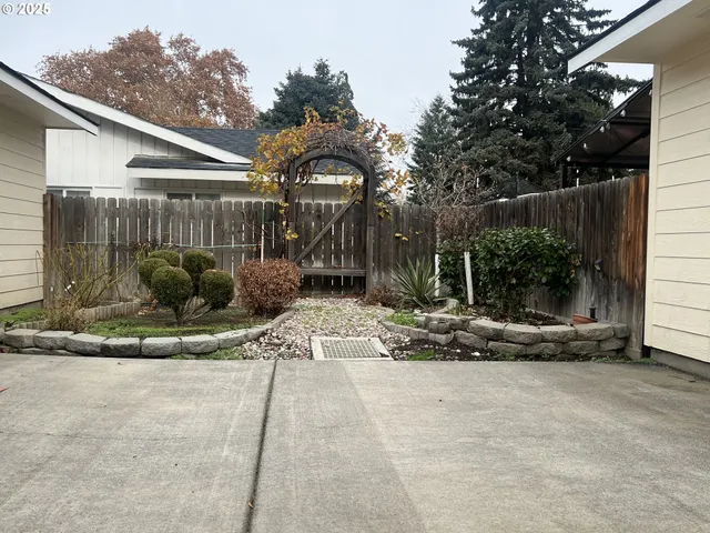 a view of a house with a yard and sitting area
