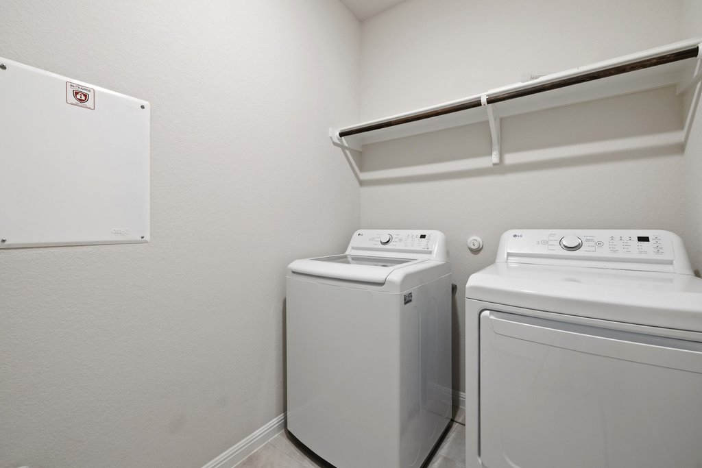 105 Cupa Monti Road Hutto, TX 78634 - Photo 22 of 28 Laundry area featuring washing machine and clothes dryer and baseboards