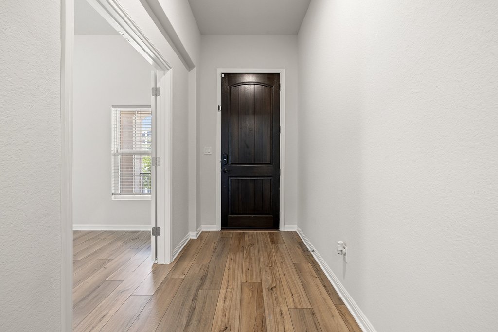 105 Cupa Monti Road Hutto, TX 78634 - Photo 3 of 28 Entryway featuring light wood-type flooring and baseboards