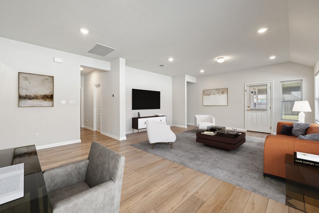 105 Cupa Monti Road Hutto, TX 78634 - Photo 10 of 28 Open-concept living space featuring light wood-finish flooring, recessed lighting, and vaulted ceilings