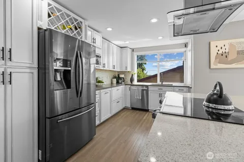 a kitchen with stainless steel appliances a refrigerator sink and cabinets