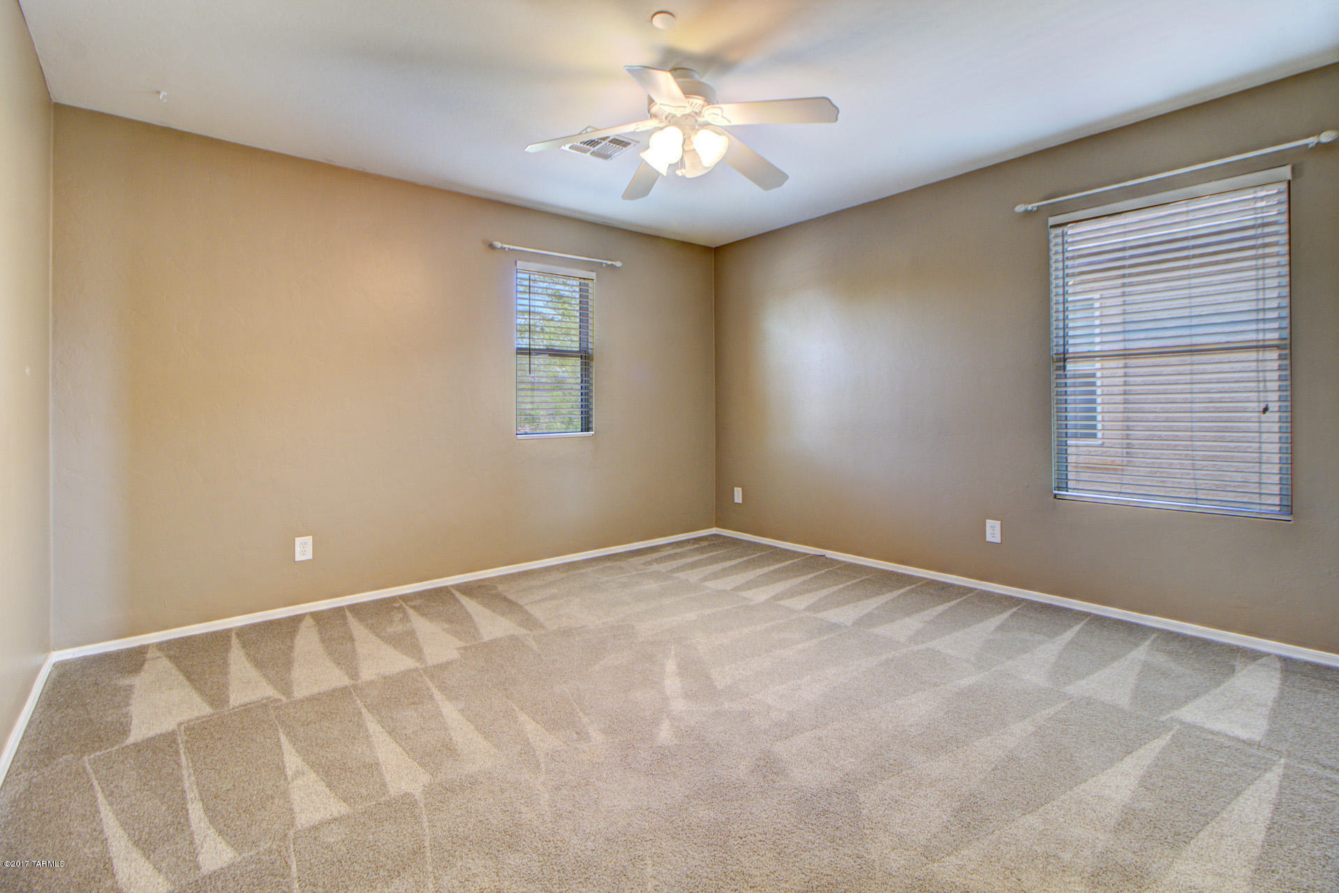 3588 East Mecate Road Tucson, AZ 85739 - Photo 21 of 36 a view of an empty room with a window