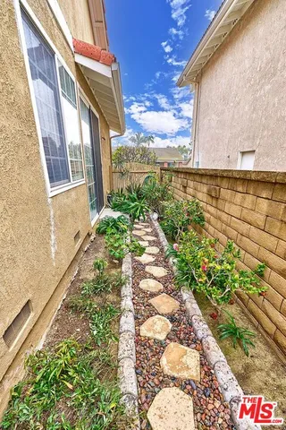 a view of a pathway both side of the house