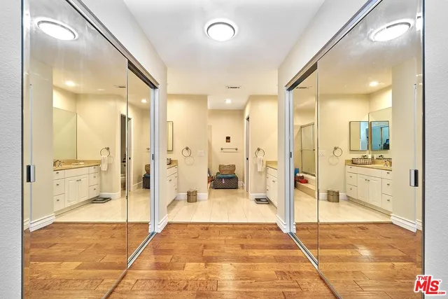 a bathroom with a glass shower door and a mirror