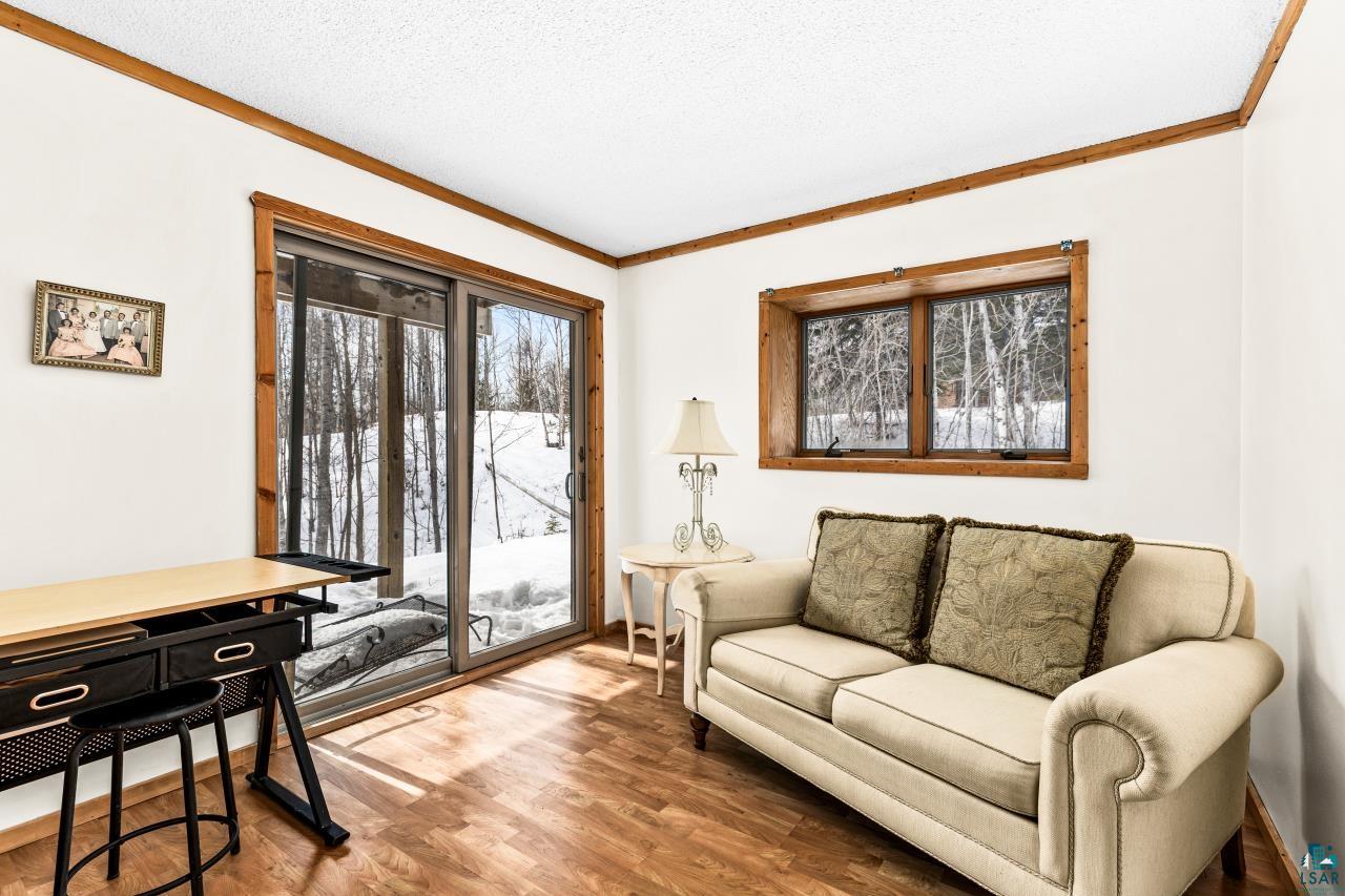 67 Snowshoe Trail Tofte, MN 55615 - Photo 32 of 42 Sitting room with wood finished floors, crown molding, and a textured ceiling