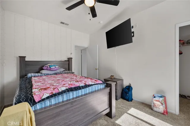 a bedroom with a bed and flat tv