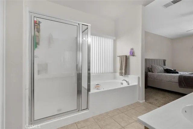 a bathroom with a tub shower and sink