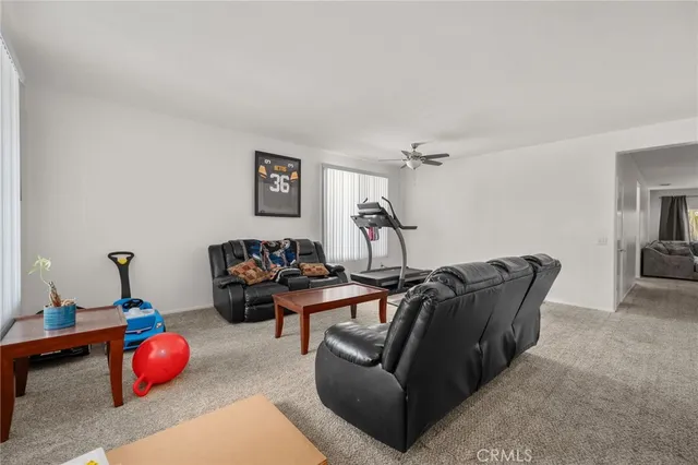 a living room with furniture gym equipment and view of living room