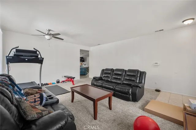 a living room with furniture a rug and a chandelier