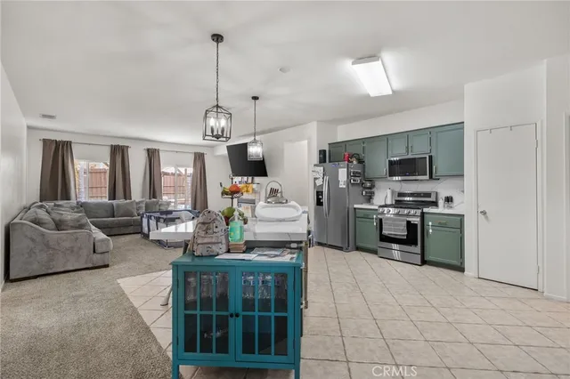 a kitchen with kitchen island granite countertop lots of counter top space and stainless steel appliances