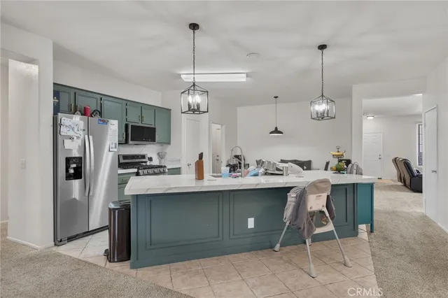 a view of kitchen with sink microwave and refrigerator