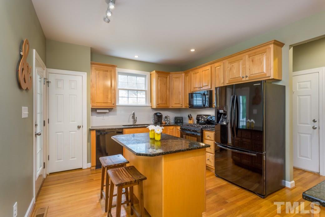 816 Nowell Ridge Road Raleigh, NC 27607 - Photo 4 of 9 a kitchen with stainless steel appliances granite countertop a refrigerator a stove a sink dishwasher and a refrigerator with wooden floor
