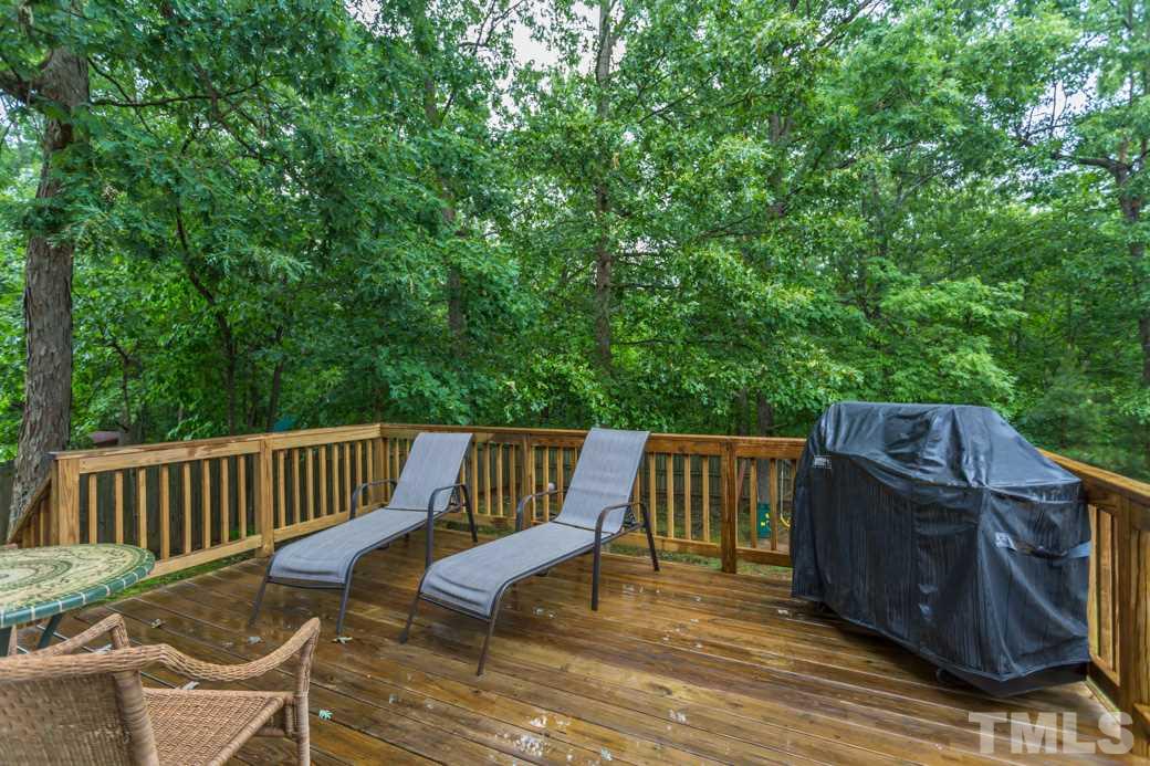 816 Nowell Ridge Road Raleigh, NC 27607 - Photo 8 of 9 a view of a deck with two chair and wooden floor