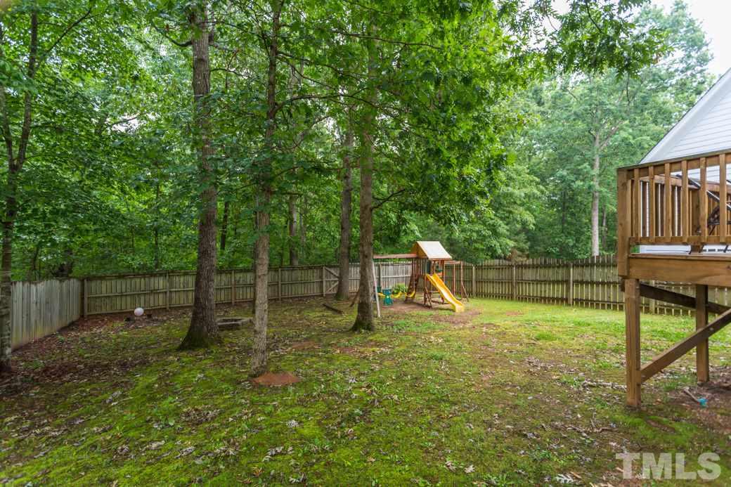816 Nowell Ridge Road Raleigh, NC 27607 - Photo 9 of 9 a backyard of a house with entertaining space and deck