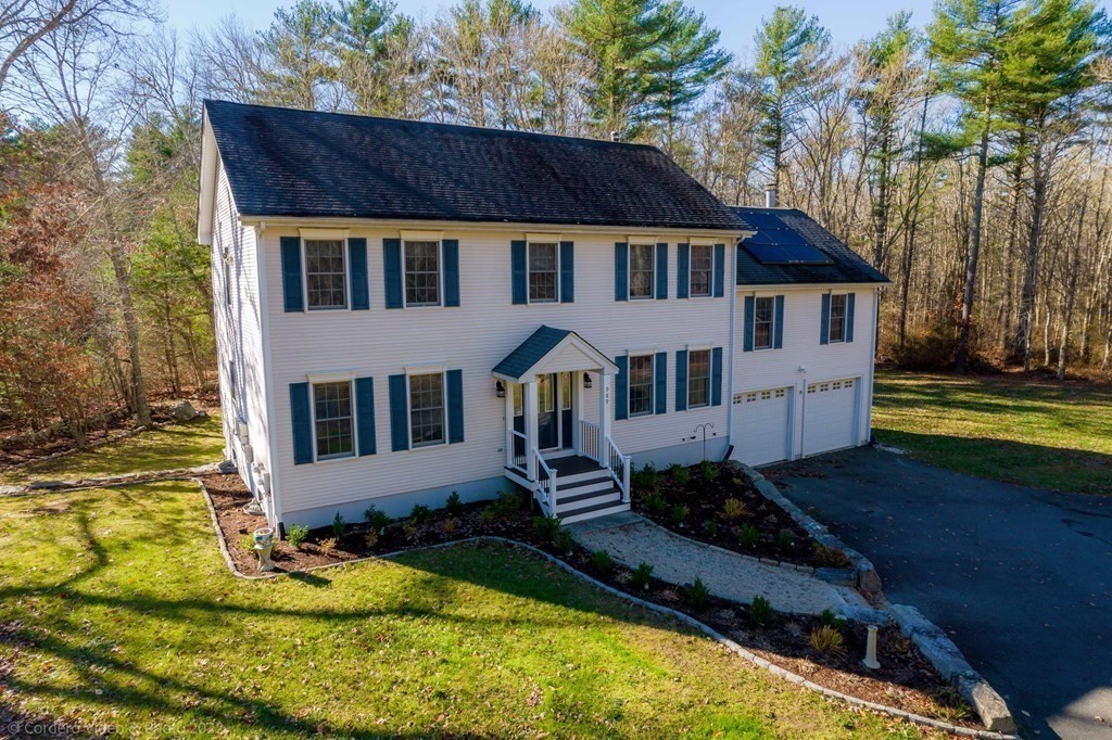 989 Walnut Plain Road Rochester, MA 02770 - Photo 1 of 41 a house with trees in the background