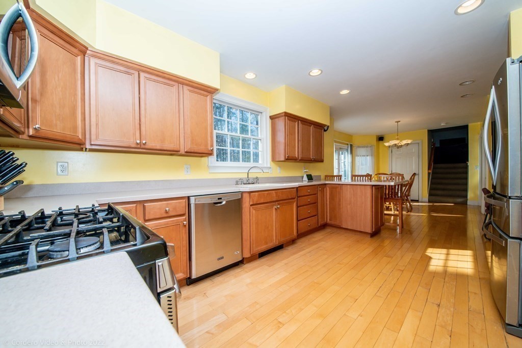 989 Walnut Plain Road Rochester, MA 02770 - Photo 14 of 41 a kitchen with stainless steel appliances stove refrigerator sink and cabinets