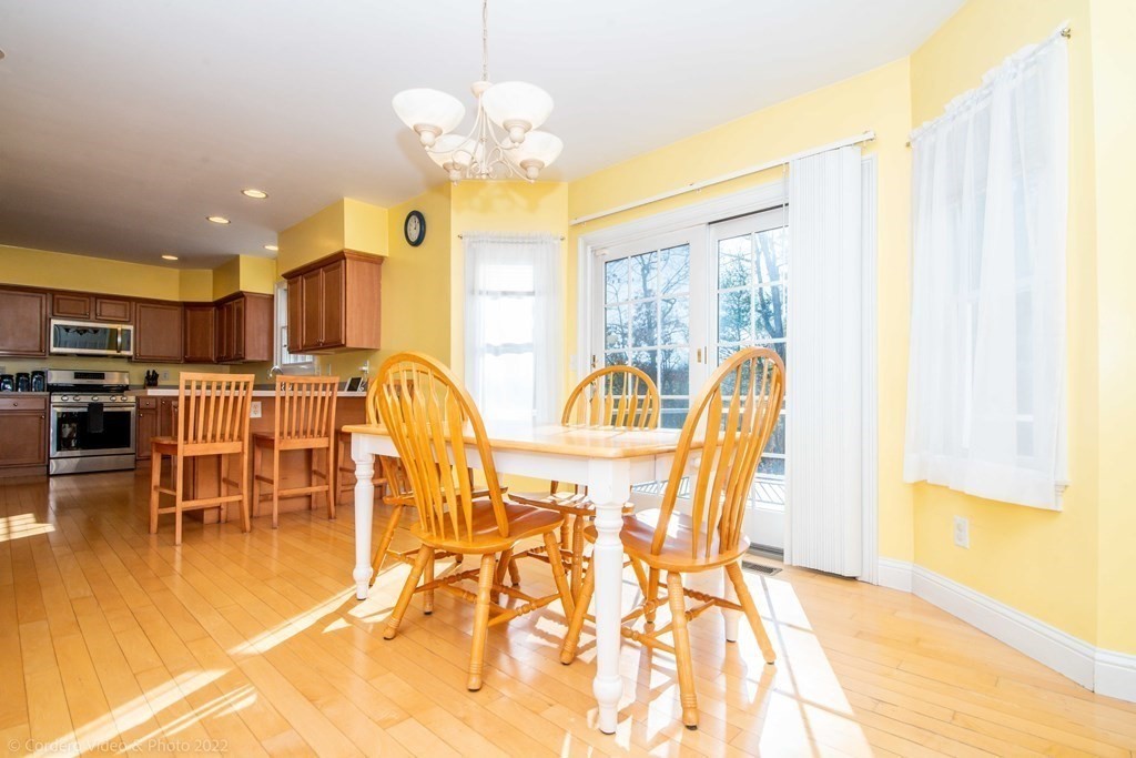 989 Walnut Plain Road Rochester, MA 02770 - Photo 18 of 41 a view of a dining room with furniture and a chandelier