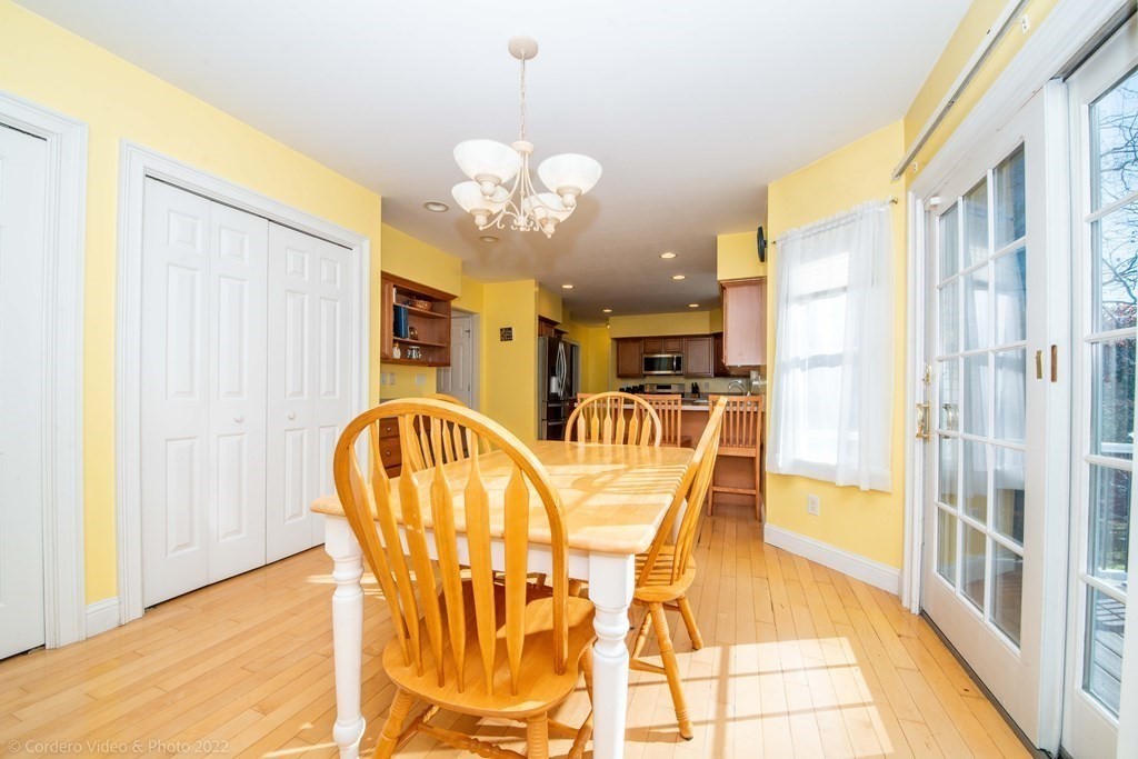 989 Walnut Plain Road Rochester, MA 02770 - Photo 19 of 41 a view of a dining room with furniture and a chandelier