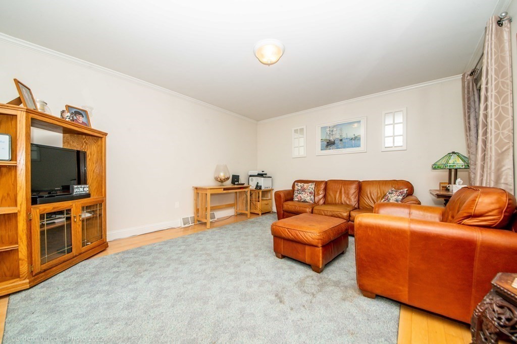 989 Walnut Plain Road Rochester, MA 02770 - Photo 24 of 41 a living room with furniture and a flat screen tv
