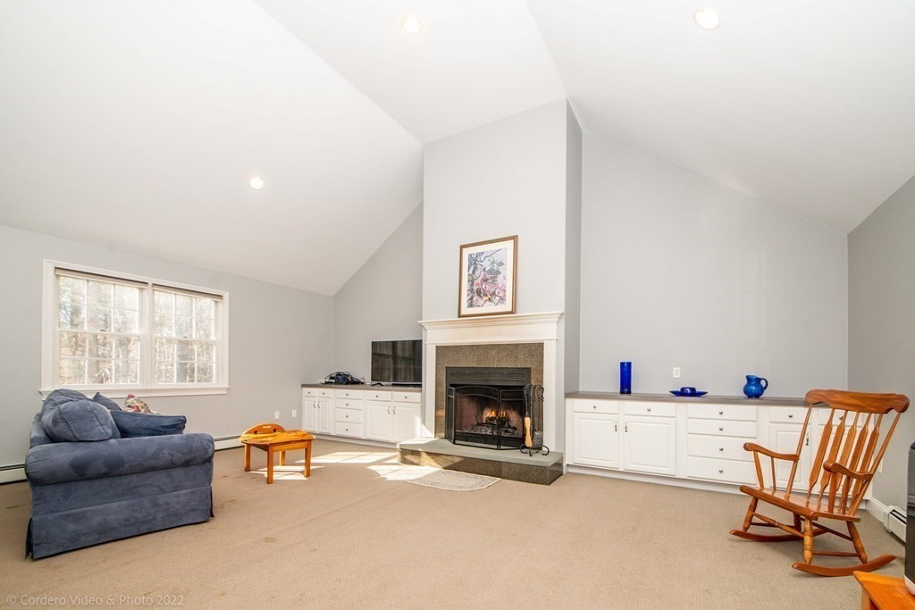 989 Walnut Plain Road Rochester, MA 02770 - Photo 27 of 41 a living room with furniture and a fireplace