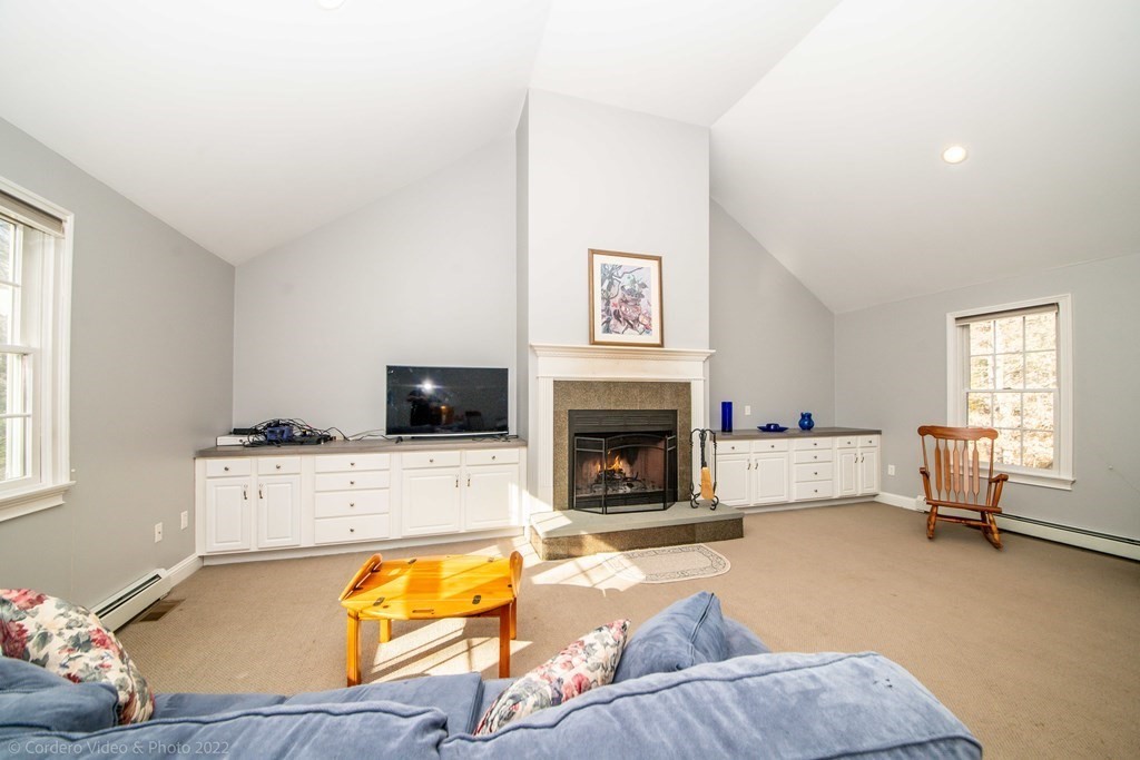 989 Walnut Plain Road Rochester, MA 02770 - Photo 28 of 41 a living room with furniture and a fireplace