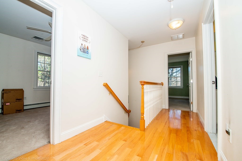 989 Walnut Plain Road Rochester, MA 02770 - Photo 31 of 41 a view of a bedroom with wooden floor and stairs