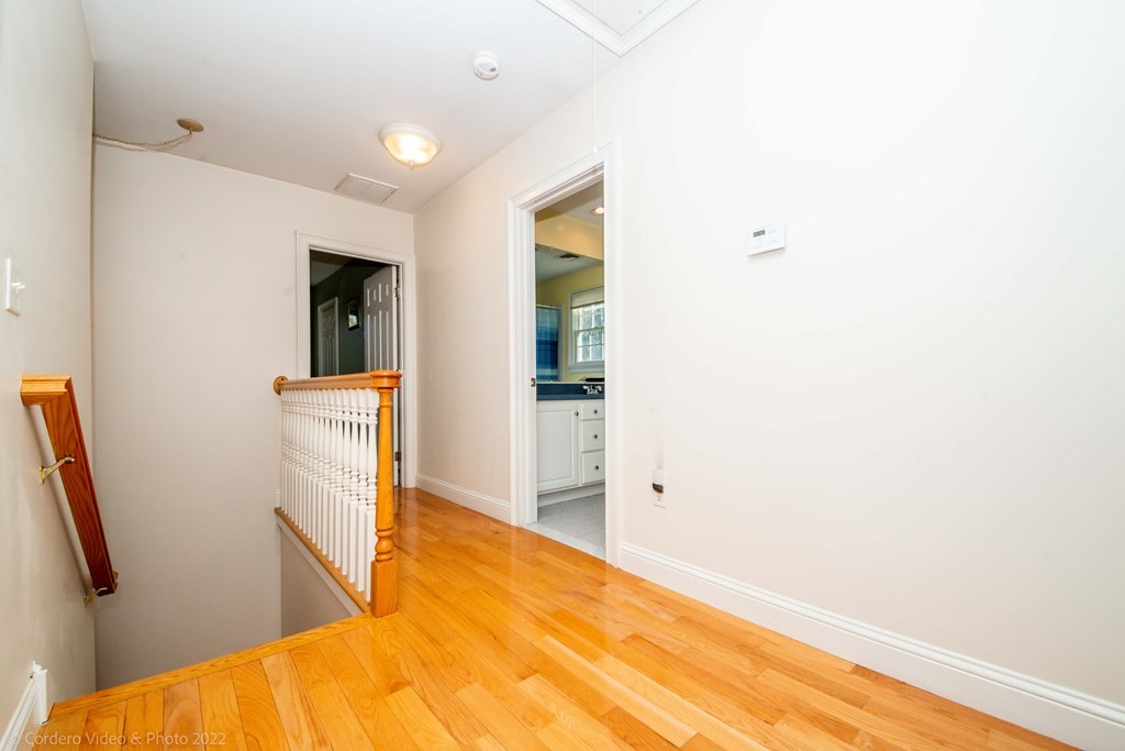 989 Walnut Plain Road Rochester, MA 02770 - Photo 36 of 41 a view of a bedroom with wooden floor and a ceiling fan