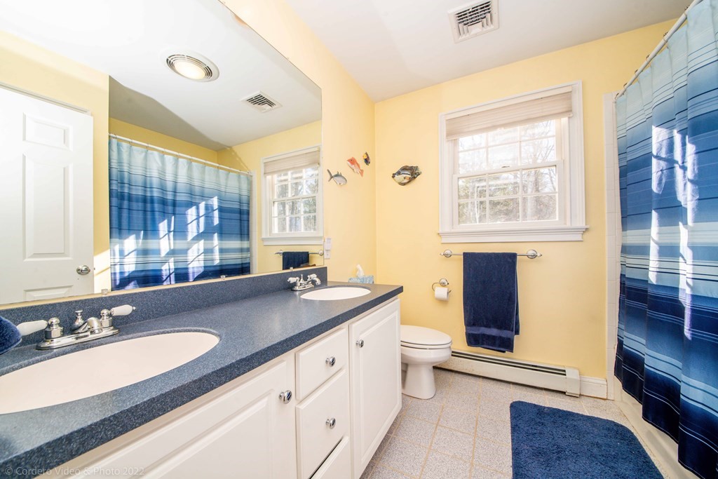 989 Walnut Plain Road Rochester, MA 02770 - Photo 38 of 41 a bathroom with a granite countertop sink double vanity and a shower