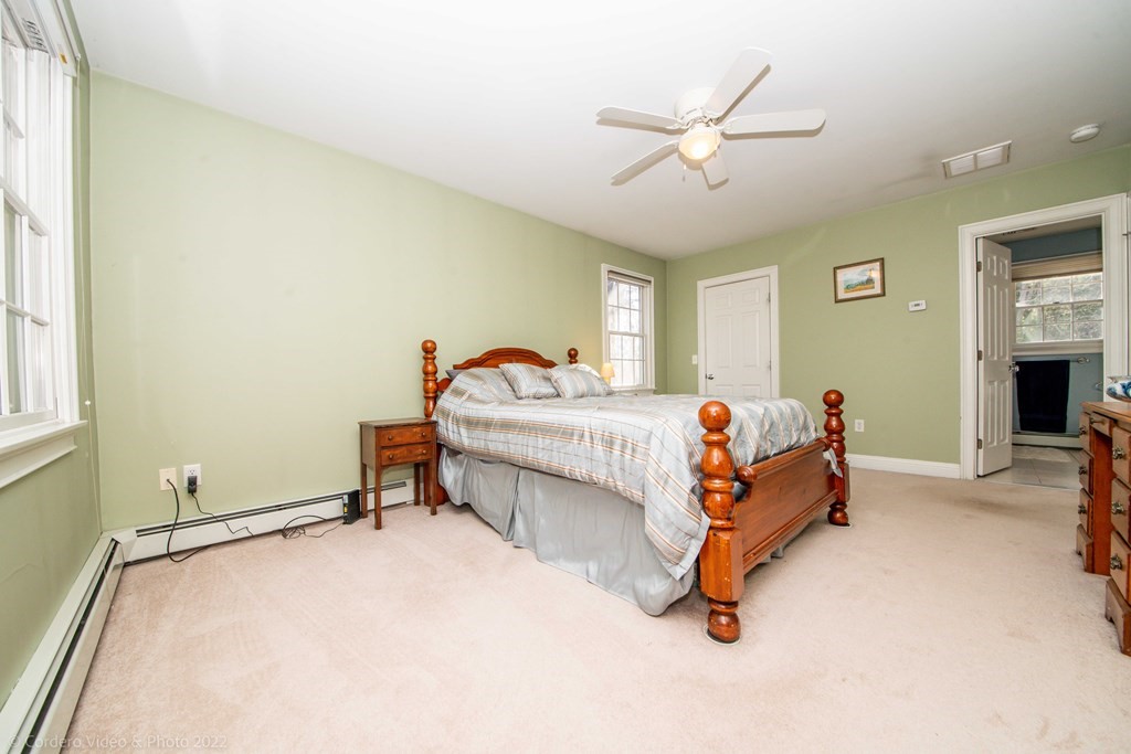 989 Walnut Plain Road Rochester, MA 02770 - Photo 40 of 41 a bedroom with a bed and a ceiling fan