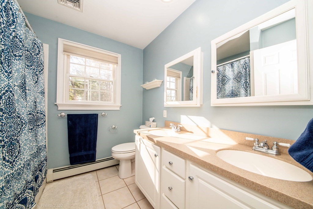989 Walnut Plain Road Rochester, MA 02770 - Photo 41 of 41 a bathroom with a double vanity sink toilet and a mirror