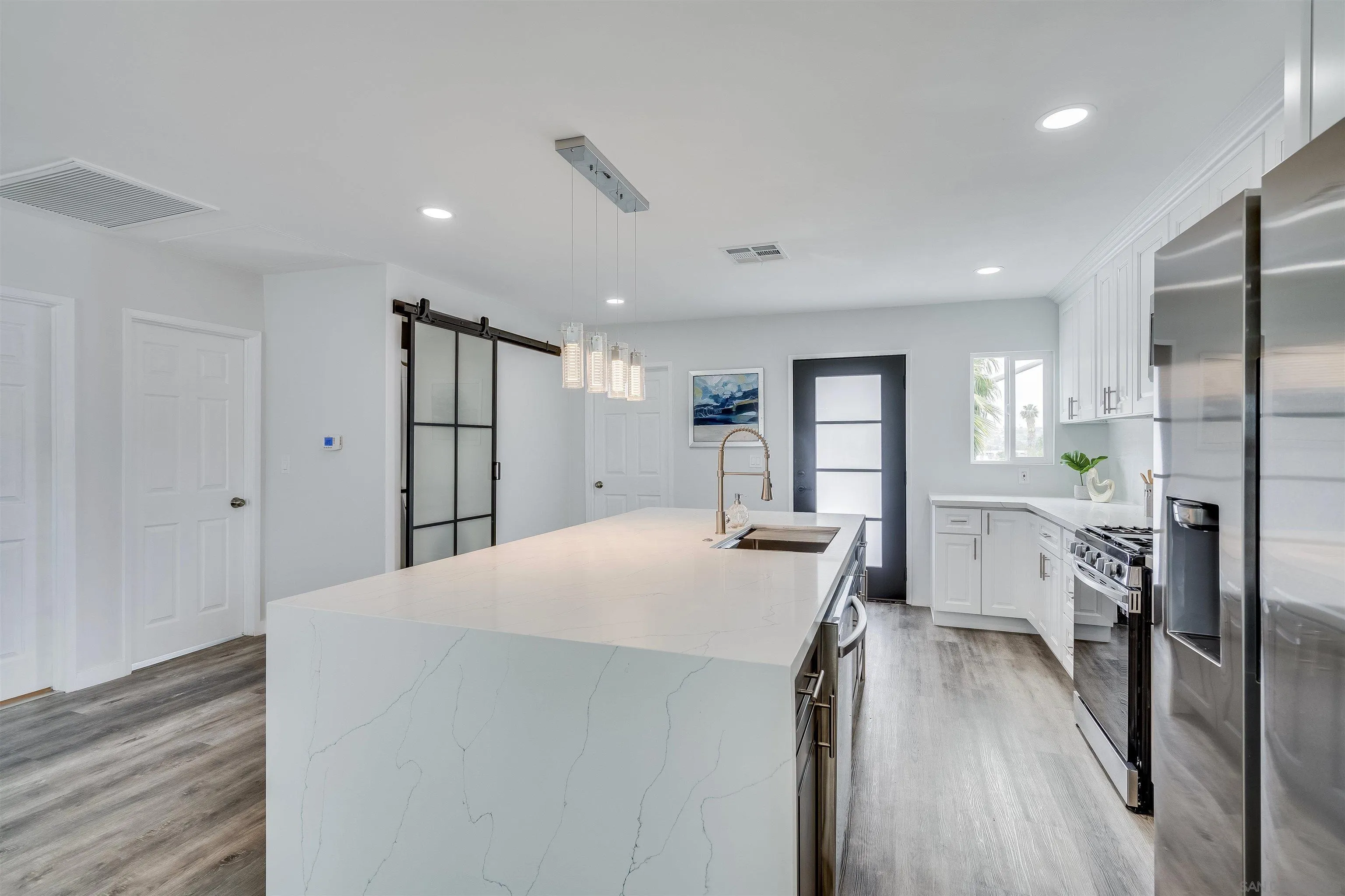 9209 Jamacha Boulevard Spring Valley, CA 91977 - Photo 11 of 22 a view of kitchen with refrigerator stove and wooden floor
