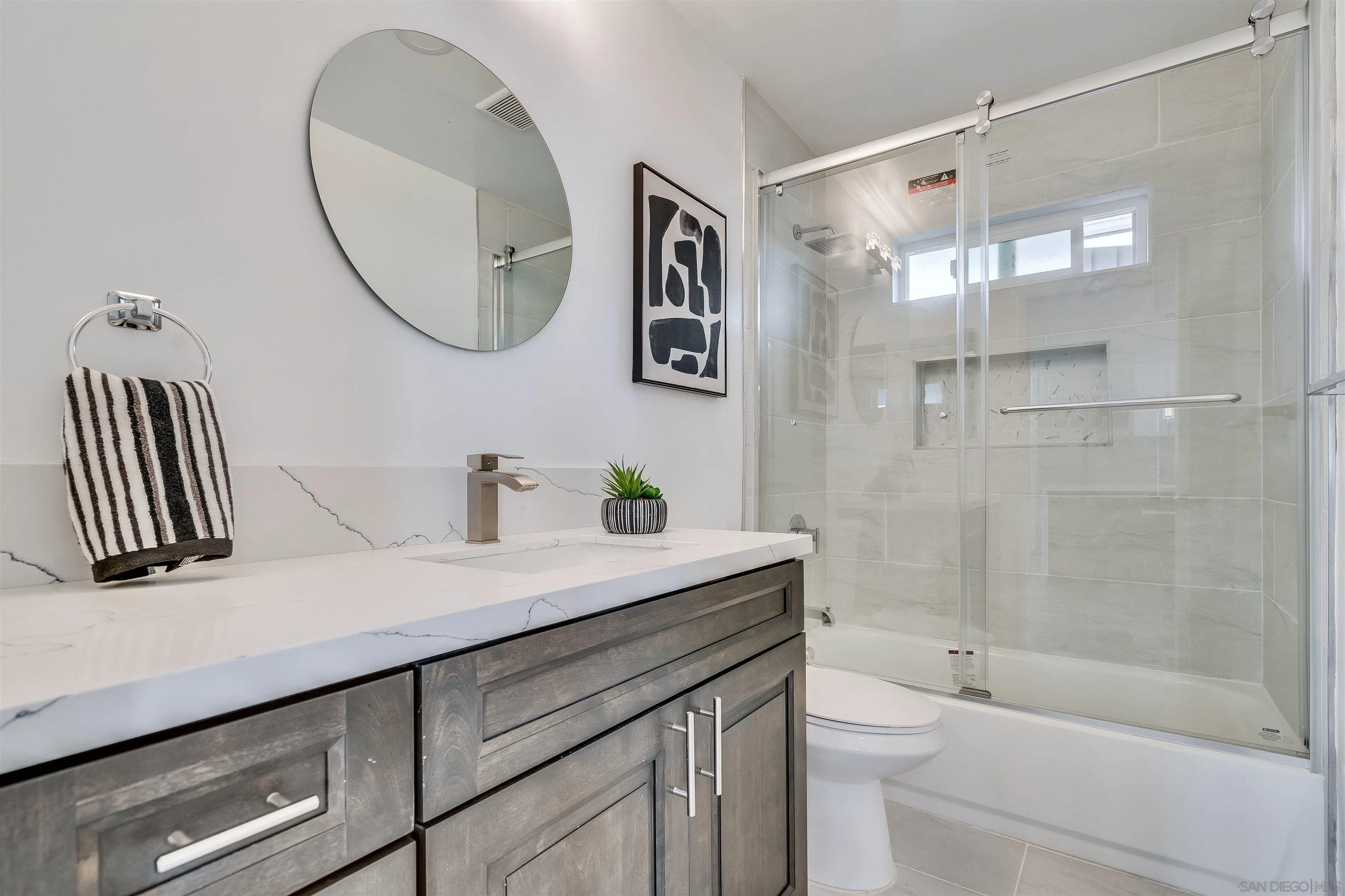 9209 Jamacha Boulevard Spring Valley, CA 91977 - Photo 18 of 22 a bathroom with a sink a toilet and a mirror