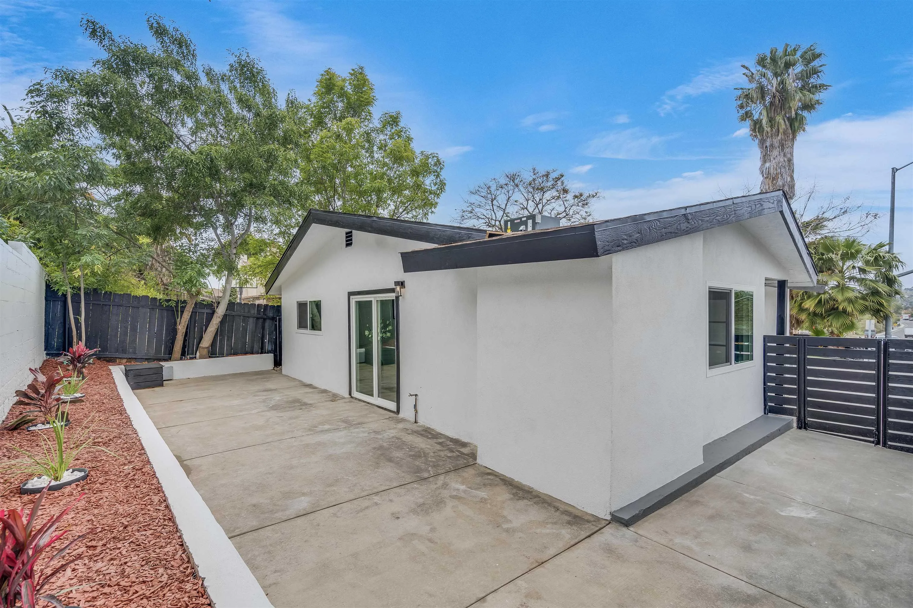 9209 Jamacha Boulevard Spring Valley, CA 91977 - Photo 21 of 22 a view of a house with a backyard and a tree