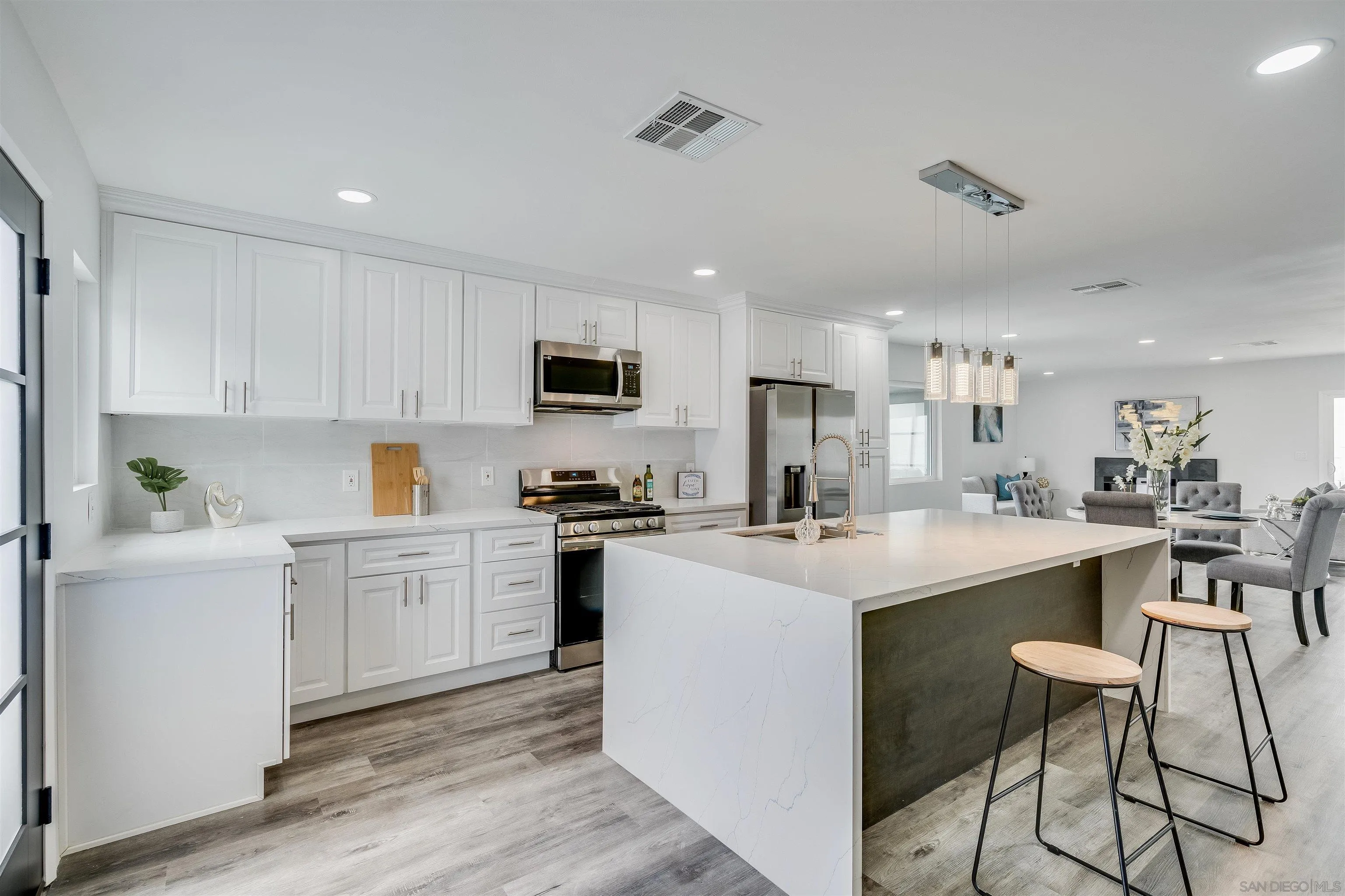 9209 Jamacha Boulevard Spring Valley, CA 91977 - Photo 8 of 22 a kitchen with white cabinets stainless steel appliances and sink