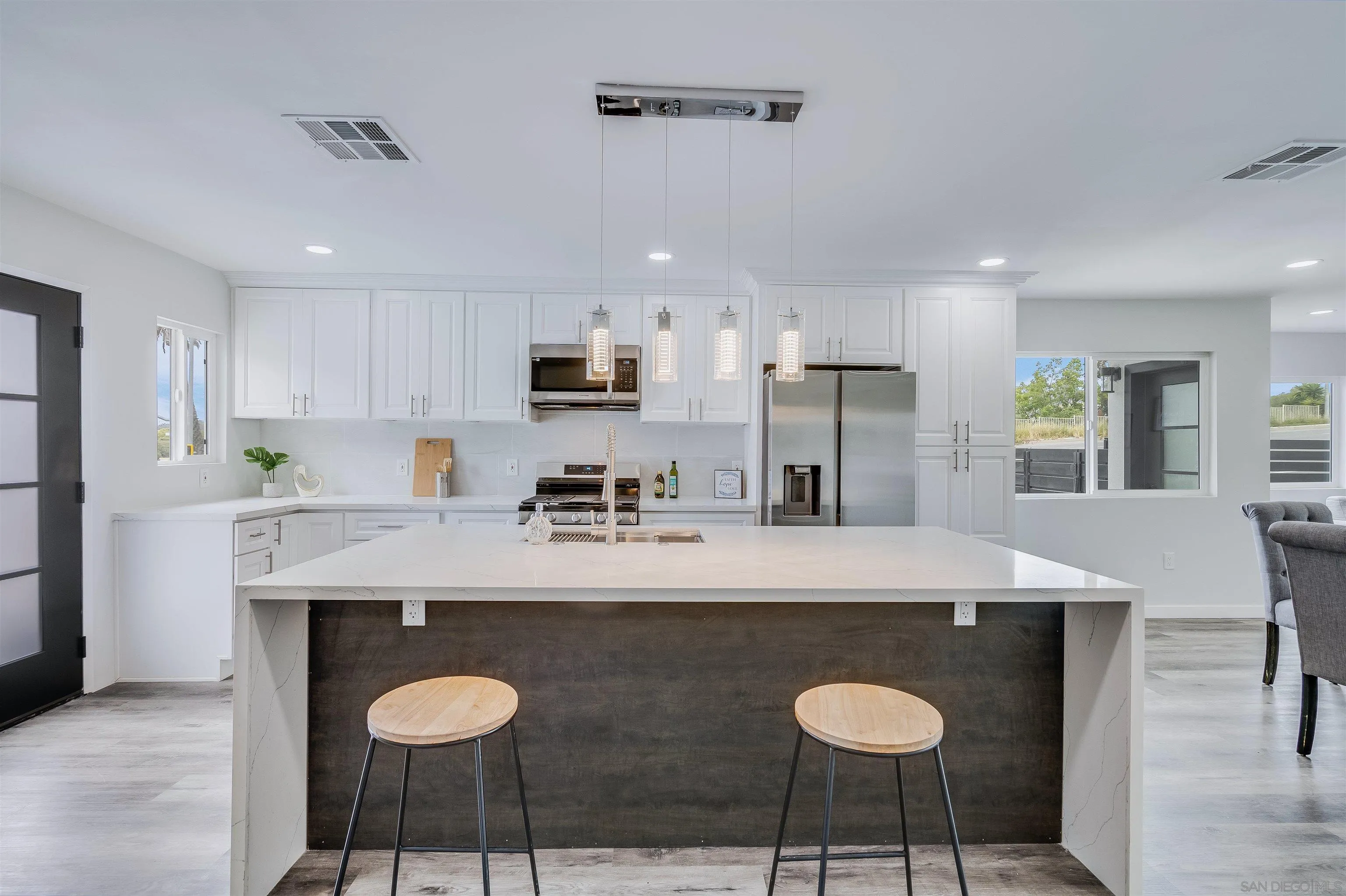 9209 Jamacha Boulevard Spring Valley, CA 91977 - Photo 9 of 22 a kitchen with granite countertop a counter space dining table stainless steel appliances and cabinets