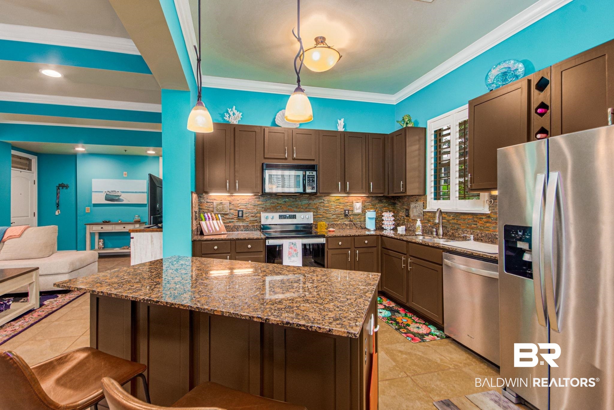 1430 Regency Road, Unit I201 Gulf Shores, AL 36542 - Photo 4 of 34 Kitchen featuring decorative light fixtures, stainless steel appliances, ornamental molding, sink, and dark stone countertops