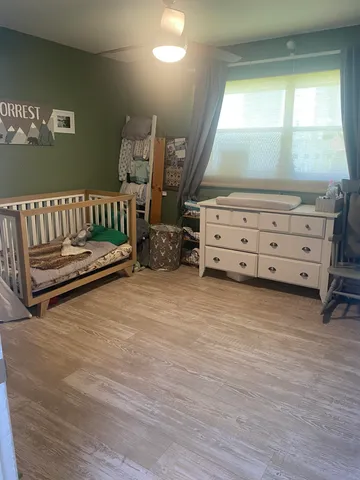 a kitchen with a refrigerator and white cabinets