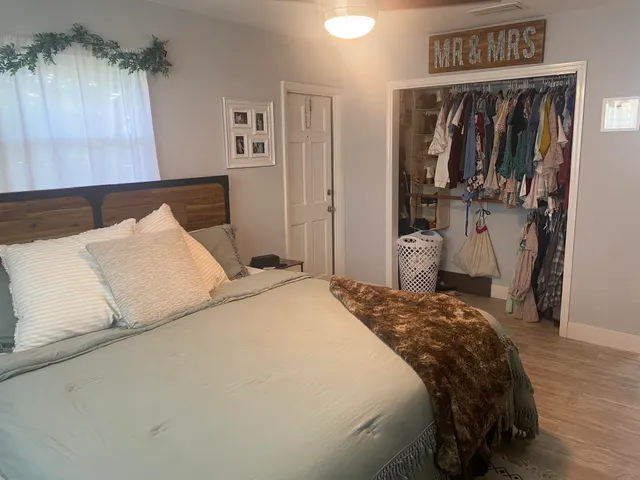 a view of a room with wooden floor and furniture