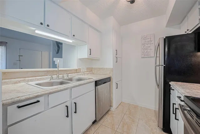 a kitchen with a sink stove and refrigerator